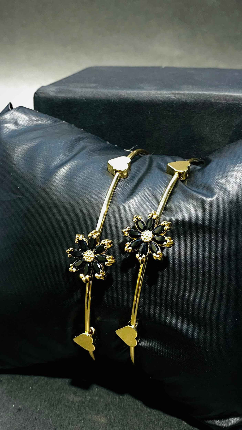 Elegant Gold Bangles with Black Floral Gemstone Accents