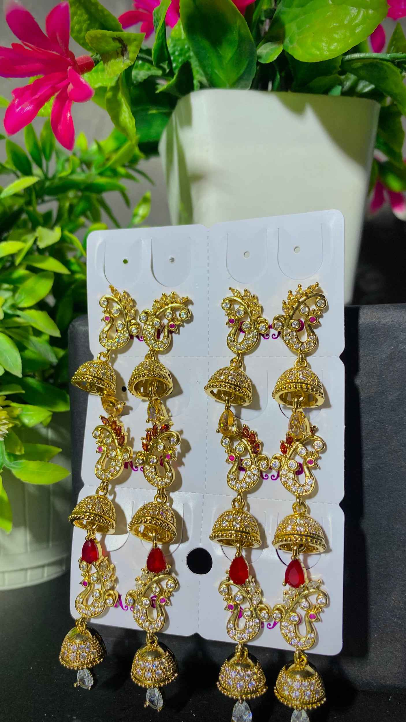 Royal Gold Jhumka Earrings with Red Stone Accents – Traditional Charm with Modern Grace