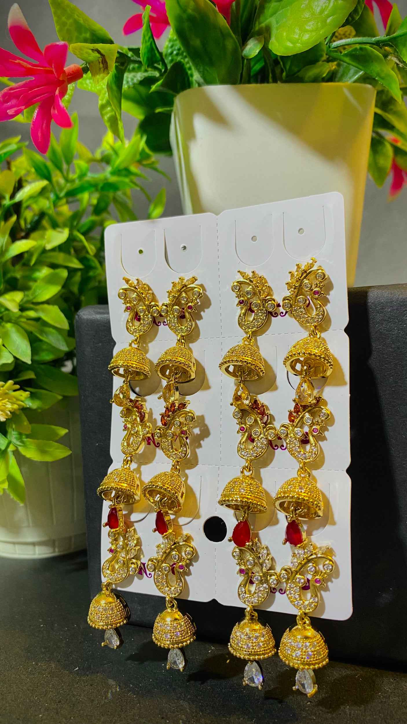 Royal Gold Jhumka Earrings with Red Stone Accents – Traditional Charm with Modern Grace
